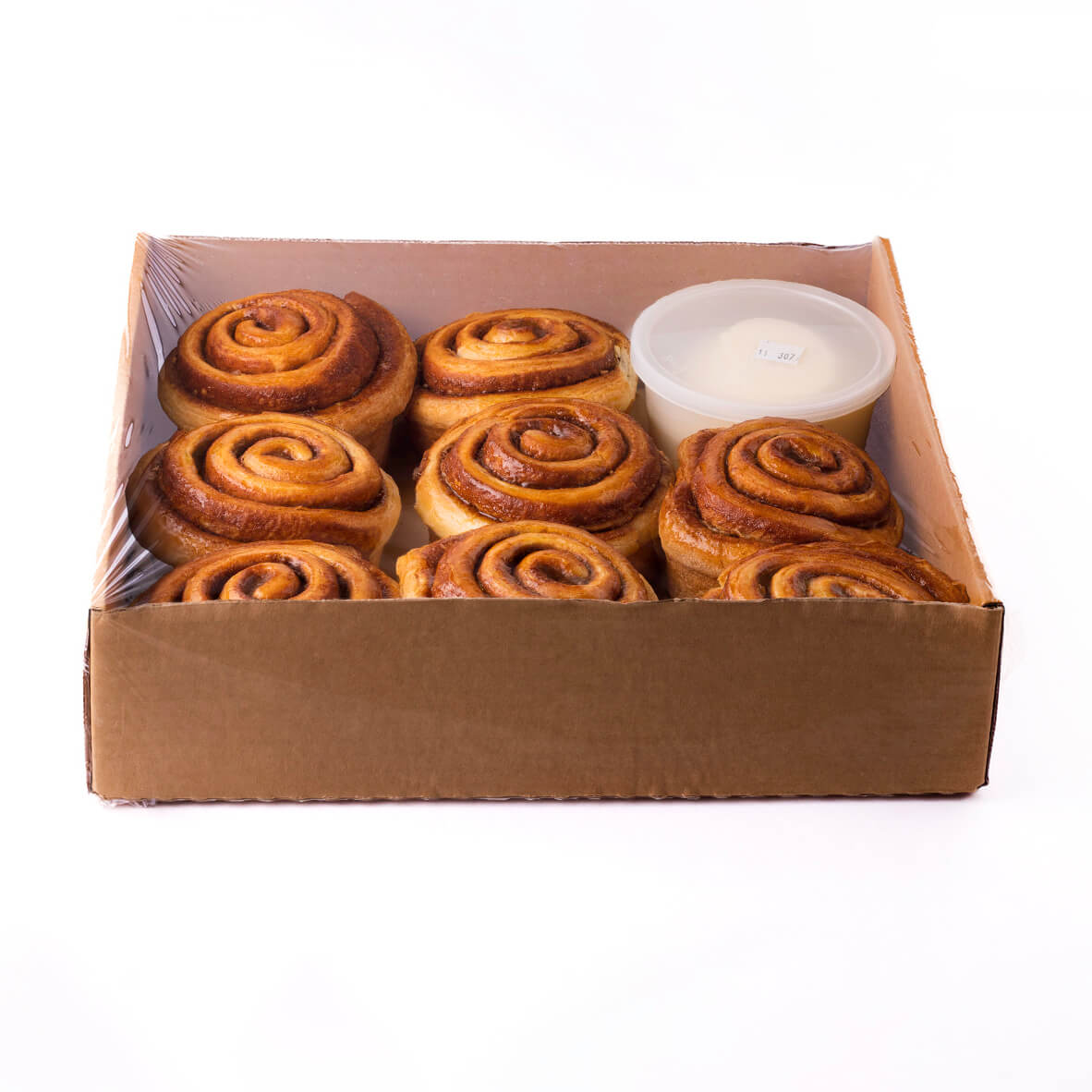 cinnamon buns in box with icing in plastic container